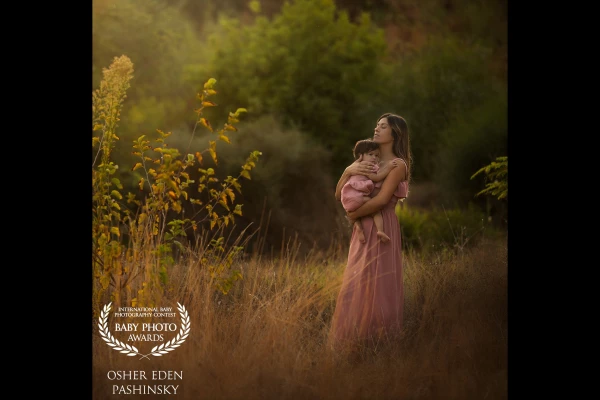 This image and its colors herald the coming of the fall, colors of regeneration, something optimistic, hope, feeling safe just like the daughter in her mother's arms. <br />
